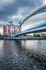 Fototapeta premium Foot bridge cross Manchester ship canal, connecting between Media City and Imperial War Museum at Salford quays in Manchester city, England 