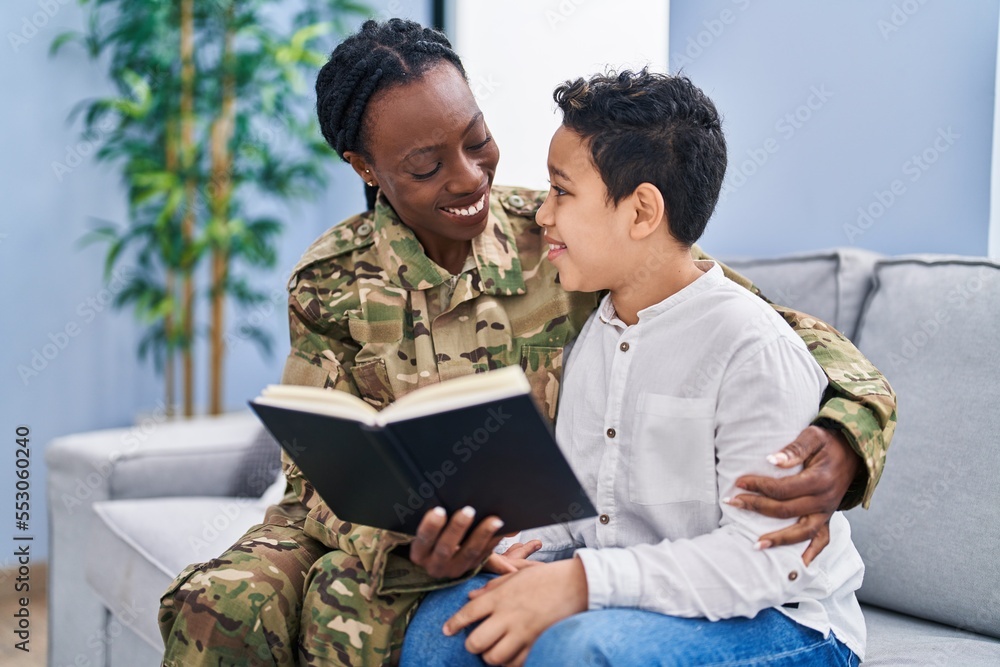 Canvas Prints african american mother and son wearing soldier uniform reading book at home - Canvas Prints