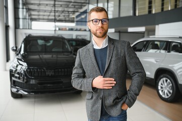 Portrait of happy customer buying new car.