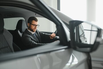 Handsome male taxi driver in car.