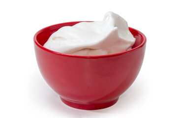 Beaten egg whites in the red ceramic bowl