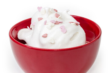 Beaten egg whites sprinkled with heart-shaped decorations in bowl