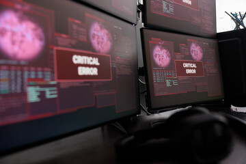 Close up of multiple monitors having critical error message on display after cyber crime attack and hacking alert. Computer screen showing digital malfunction and error threat, system crash.