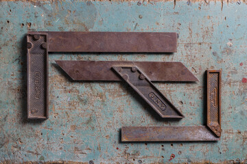 Vintage woodworking square tools flat lay on a rustic surafce