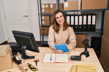 Young woman ecommerce business worker using touchpad at office