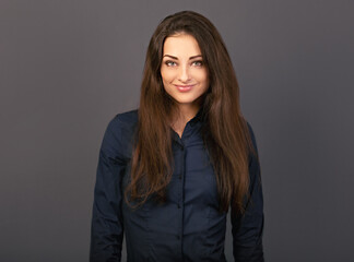 Obraz premium Beautiful confident thinking smiling business woman in blue formal shirt on grey background with empty copy space for text. Closeup