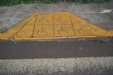 Wheelchair ramp on the curb in the small town of Puerto Iguazu, Misiones province, Argentina, South America.