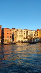 Fototapeta na wymiar View of the Venetian Canal on a sunny day, buildings and boats. Venice, Italy