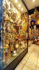 A showcase with Venetian masks, expensive carnival decorations, a souvenir from Venice, Italy