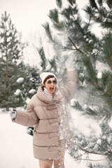 Outdoor photo of cozy female in winter forest