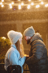 Young couple outdoor in night street at christmas time