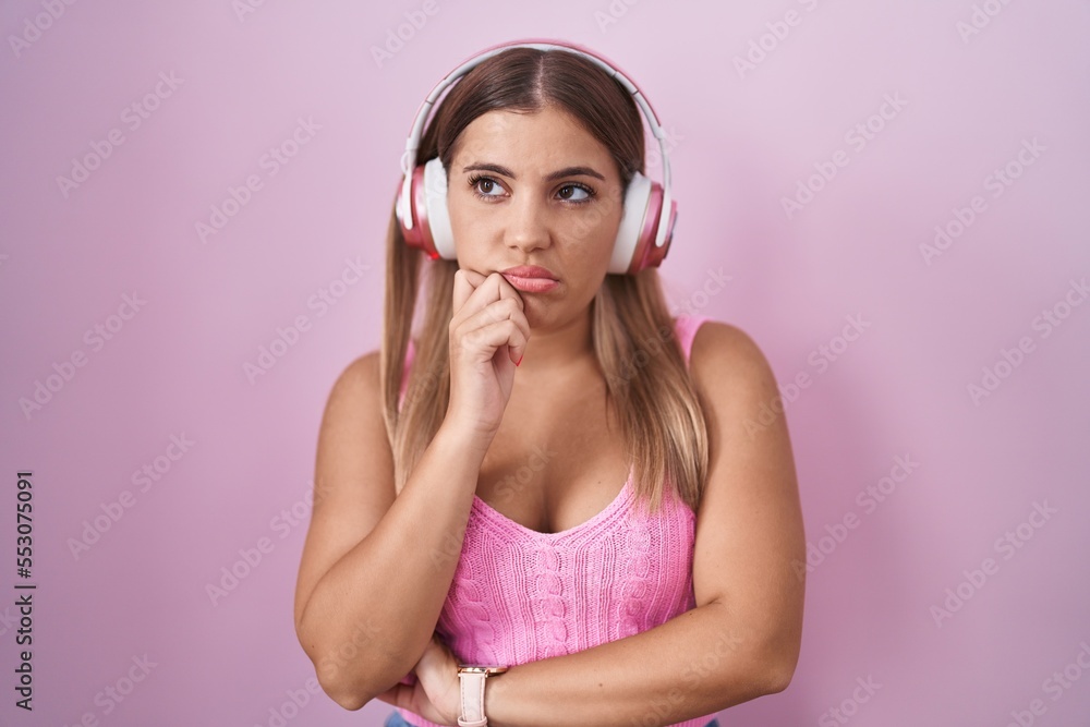 Canvas Prints young blonde woman listening to music using headphones thinking looking tired and bored with depress