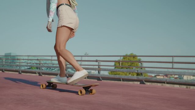 Girl pushing a longboard to have a fast ride