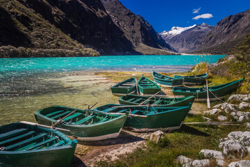 Fototapeta na wymiar Llanganuco lake with boats in Cordillera Blanca, snowcapped Andes, Ancash, Peru