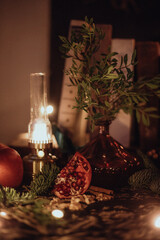 Christmas dark academia vintage romantic table for two with red and gold balls ornaments, fir, candles and mulled wine