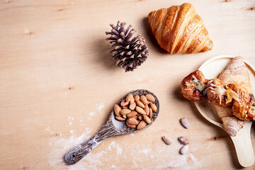 Topview shot of almonds with big slices of bread on dark wooden background concept of health care
