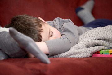 young boy taking a nap on the couch