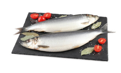 Slate plate with salted herrings, bay leaves, cherry tomatoes and spices isolated on white