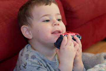 Expressive young boy playing with toys at home