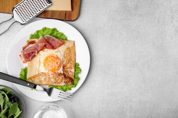 Delicious crepe with egg served on light gray table, flat lay with space for text. Breton galette - obrazy, fototapety, plakaty