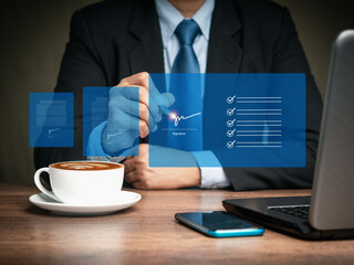 Businessman uses a pen to sign electronic documents on a virtual screen while sitting at the table