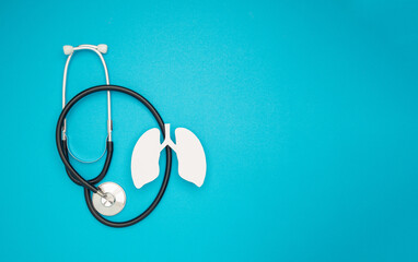 A lung symbol and a stethoscope are on a blue background
