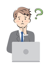 パソコン操作で悩むスーツ姿の若い男性