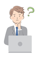 パソコン操作で悩むスーツ姿の若い男性