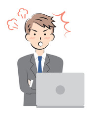 パソコン操作で怒るスーツ姿の若い男性