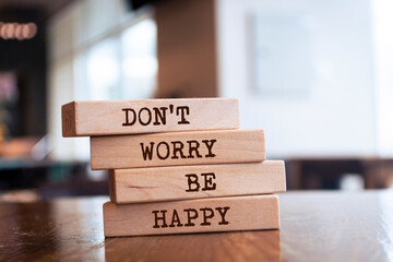 Wooden blocks with words 'Don't Worry Be Happy'.