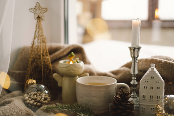 Christmas composition. Hot tea, candles, Christmas golden balls and decorations. Christmas holiday mood. Winter concept.