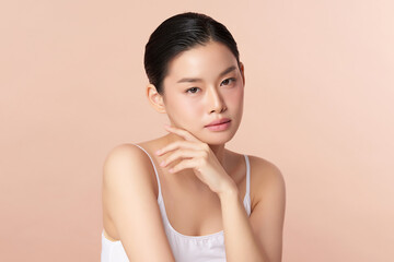 Beautiful young asian woman with clean fresh skin on beige background, Face care, Facial treatment, Cosmetology, beauty and spa, Asian women portrait.