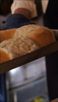 Vertical video taking out a traditional rosca de reyes.
