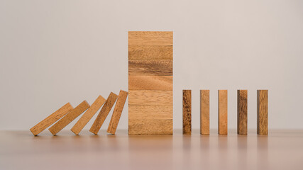 Business Risks and Strategies. Stopping Wood Block Domino. Business Crisis Impact or hedging concept, Prevention and development towards security.