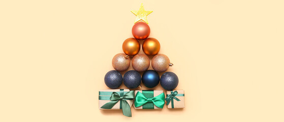 Christmas tree made of balls, star and gifts on beige background, top view