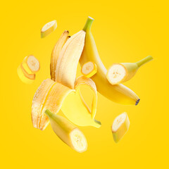 Flying fresh bananas on yellow background © Pixel-Shot