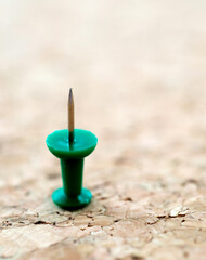 Single push pin on cork board
