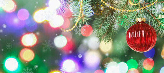 Obraz na płótnie Canvas Christmas ball hanging on fir tree against blurred lights, closeup