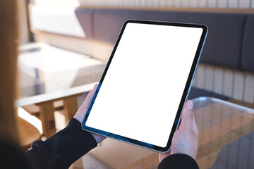 Mockup image of a woman holding digital tablet with blank white desktop screen