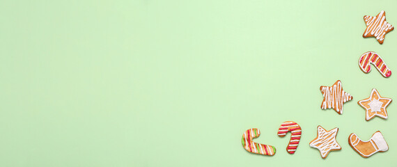 Many Christmas cookies on green background with space for text