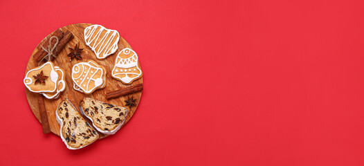 Wooden board with tasty Christmas cookies, stollen and spices on red background with space for text