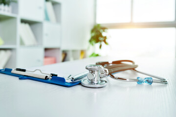 Stethoscope and medical clipboard  on doctor desk