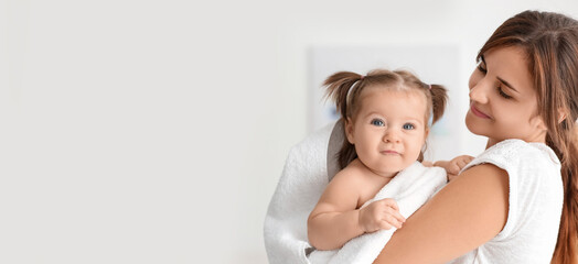 Young mother with cute little daughter at home