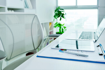 Workspace desk with laptop and digital tablet