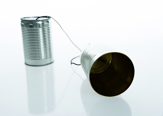 Tin can telephone with cord isolated on white background