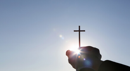 Background with a bright shining sun and a holy cross symbolizing the death and resurrection of...