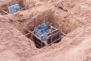 Concrete footings and reinforcing rod for building under construction.