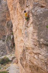 climber climbs the wall. a man is engaged in sport climbing.