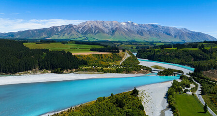 Aerial view with road of highway as bridge at Rakaia River lagoon Valley as green field againts...