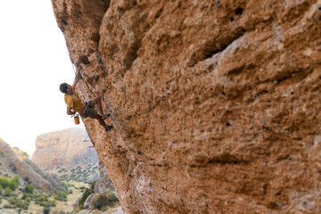 strong man climbs a beautiful rock. the concept of freedom and adventure. © zhukovvvlad